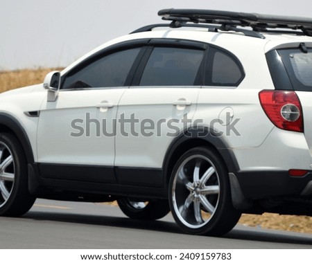Blur abstract background of a white SUV with roof rack