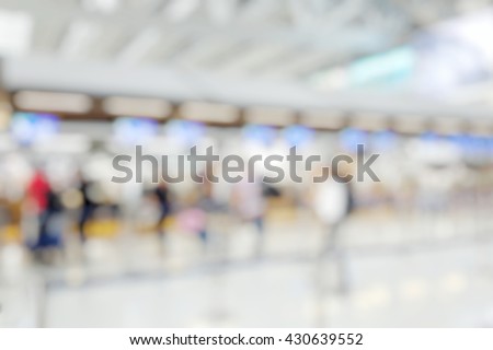 Blur abstract light background bokeh of Terminal Departure Check-in at airport. Burry view of check in counter row with passengers travelling by plane at air port. Blurred image backpacker at terminal