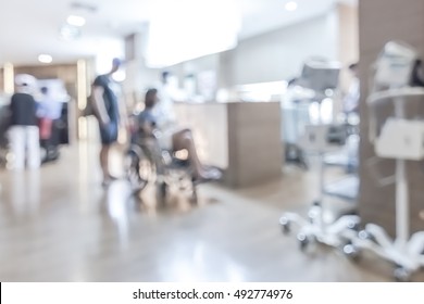 Blur Background Clinic Or Hospital Waiting Hall And Corridor With Patient On Wheelchair Near Nurse Station