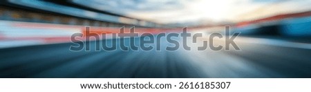 Blur Background of Dynamic Motion Blur of Race Track at Diverse Angle During Sunset with Dramatic Cloudy Sky. Defocused Image for Background.