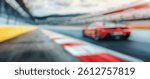 Blur Background of Dynamic Red Sports Car Racing on Track with Dramatic Landscape and Motion Blur for High-Octane Imagery. Defocused Image for Background.