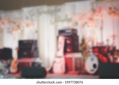 Blur Background Of Empty Abstract Light Illuminated Stage With Drum Kit And Microphone. Drums In Light During Celebrations On Wedding Stage.