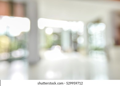 Blur background empty room of office building lobby with glass window wall bokeh light