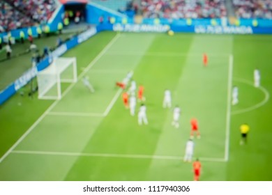 The blur background of football Blurred crowd of spectators on a stadium with an action in football match.