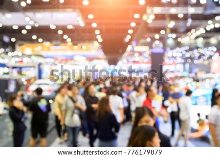 blur background of international motorshow, Bangkok , Thailand. car show room. Abstract blurred image people in international cars exhibition show in geneva.
