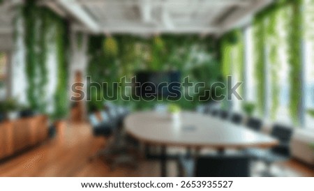 Blur background of office interior with large windows with city urban view, plants, and wooden desks at sunset. Modern workplace and urban greenery concept. Design for poster, wallpaper. Spate.