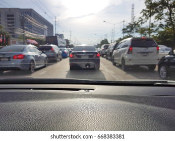 Blur Background Of POV Front Driving A Car Or Vehicle In Traffic Jam In The Evening, Bangkok. Focusing On The Car Console