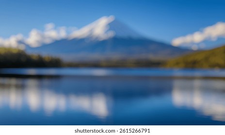 Blur Background of Snow-Capped Mountain Reflection on Calm Lake Under Clear Blue Sky with Fluffy White Clouds. Defocused Image for Background.