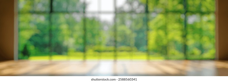 Blur Background of Spacious interior view of modern room with large glass windows overlooking serene green garden landscape. Defocused Image for Background.