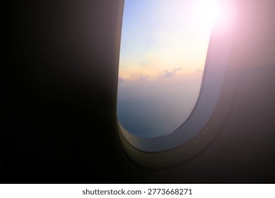 Blur background of the sunset light view through airplane window.