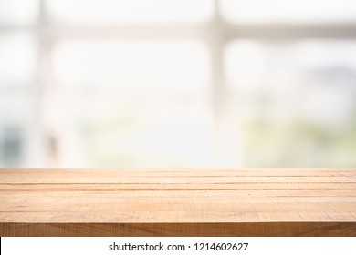 Blur Background Of White Window Glass And Green View From Garden With Epty Of Wood Table. Using For Mock Up Template For Craft Display Of Your Design,Banner For Advertise Of Product.