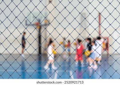 blur basketball court by rope mesh net fence focus with many asian children or kid learning training shooting to playing basketball with coach and basketball hoop for healthy sport exercise background - Powered by Shutterstock