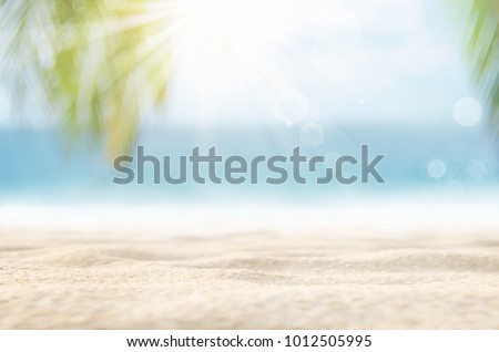 Blur beautiful nature green palm leaf on tropical beach with bokeh sun light wave abstract background. Copy space of summer vacation and business travel concept. Vintage tone filter effect color style