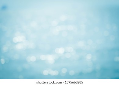 Blur beautiful nature on tropical beach with bokeh sun light wave abstract background.