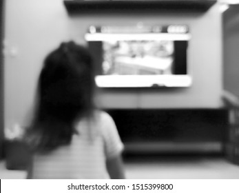 Blur Behind Child Sitting Watching Television In Black And White Tones