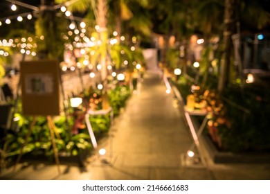 Blur Bokeh Decorative Night Wedding Outdoor In Garden With String Lights Hanging On Tree.