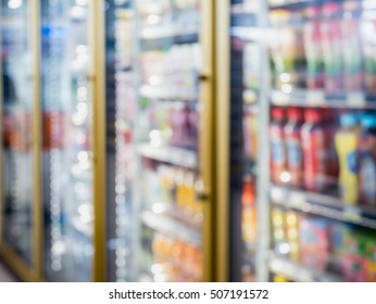 Blur Bottles Of Cold Drink Beverage Showing On Shelves In The Cold Freezer At Supermarket Or Convenience Store