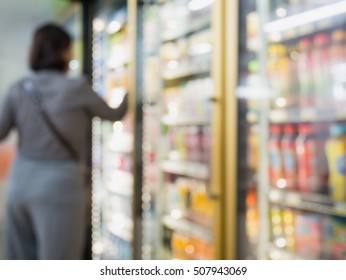 Blur Bottles Of Cold Drink Beverage Showing On Shelves In The Cold Freezer At Supermarket Or Convenience Store