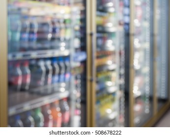 Blur Bottles Of Cold Drink Beverage Showing On Shelves In The Cold Freezer At Supermarket Or Convenience Store