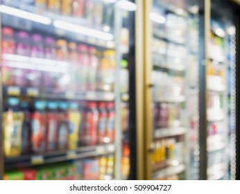 Blur Bottles Of Cold Drink Beverage Showing On Shelves In The Cold Freezer At Supermarket Or Convenience Store