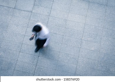 Blur Business Man Walking And Using Smart Phone On The Street