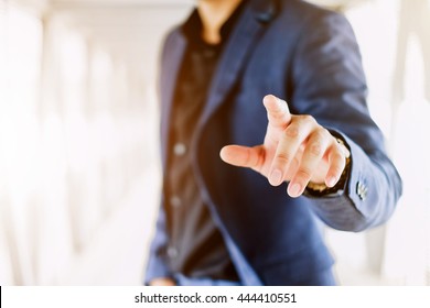 Blur businessman pushing on a touch screen interface - Powered by Shutterstock