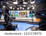 Blur camera in studio are broadcasting journalists reading news.