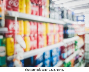 Blur Can And Bottle Of Cola, Soda, And Carbonated Drink For Sale In A Local Convenience Store