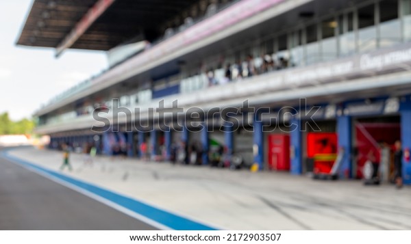 Blur car pit stop lane for race car being serviced ,\
Pit stop for racing car.