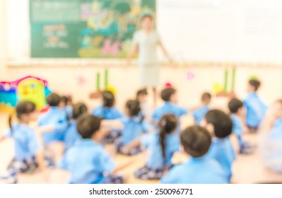 Blur Classroom  With Teacher And Kids In Uniform