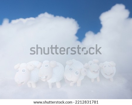Blur cloud and sky background with faded toy sheep from double exposed photo with space for runaround or wraparound text 
