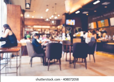 Blur Of Coffee Shop / Cafe Restaurant With Businessman In Light Gold Color Background.For Modern Lifestyle Concept