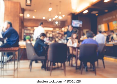 Blur Of Coffee Shop / Cafe Restaurant With Businessman In Light Gold Color Background.For Modern Lifestyle Concept