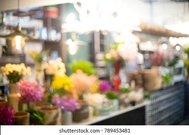 Blur Coffee Shop Interior Room Table Counter With Bokeh Light With Color Flower