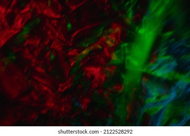 Blur color background  Creased texture  Distressed material  Defocused neon light red green blue glow defect dark shiny rough foil structure grunge overlay 