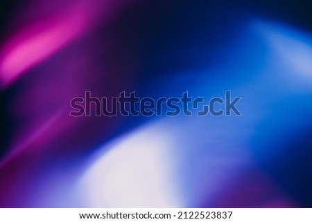 Blur color glow. Fluorescent background. Night party light. Defocused neon purple blue illumination rays on dark abstract overlay.