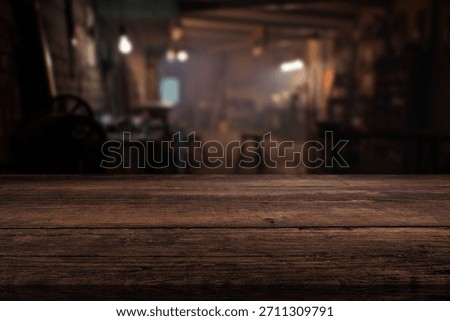 Blur craft workshop interior and empty wooden table top with space for products.