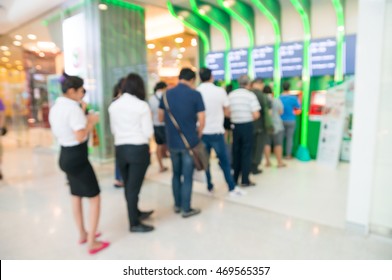 Blur Or Defocus Background Of People Line Up To Use Banking Machine Or ATM(Automatic Teller Machine) To Deposit, Withdraw And Transfer Money.