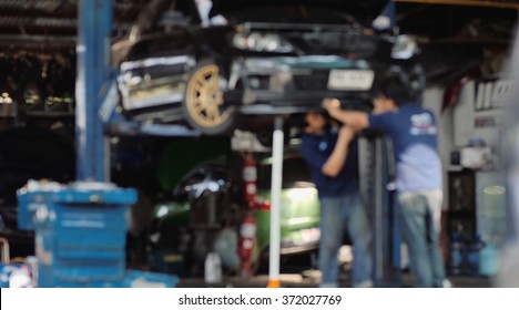 Blur Or Defocus Image Of Mechanic Working In Auto Repair Garage. Car Maintenance.