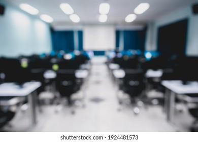Blur and defocus of lecture or class room in the university which have white screen for presentation, conference as modern education