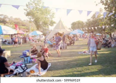Blur defocused background of people, family in park fair, festive summer, music festival tent - Shutterstock ID 599969519