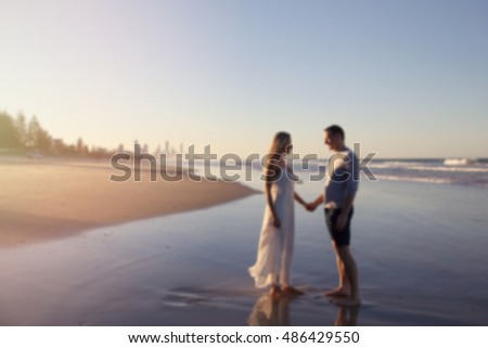 Blur defocused photo of loving couple on the beach, love concept, retro tone