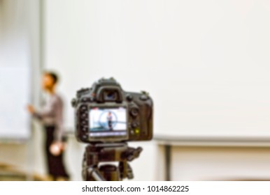 Blur. A Digital Camera On A Tripod Removes The Lecturer, Speaking In Front Of The Audience. Blurred Image, Fotone Imageinstitute, University, College