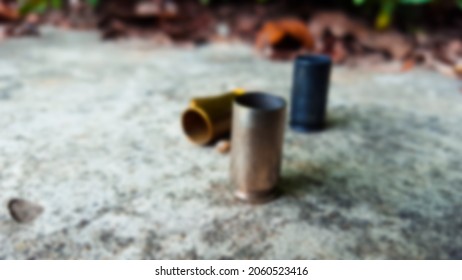 Blur Empty Pistol Bullet Shells On Concrete Ground In A Shooting Range