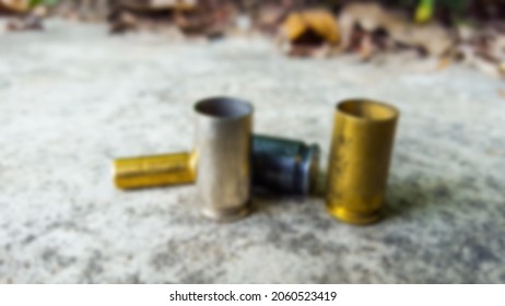 Blur Empty Pistol Bullet Shells On Concrete Ground In A Shooting Range