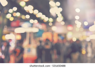 blur event with people background -  blurred electronic technology photo fair bokeh light vintage tone - business concept