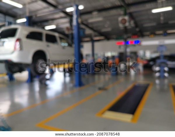 Blur focus of auto repair service station -\
electric lift for lifting cars that come to change the engine oil\
periodically in the car care\
center.