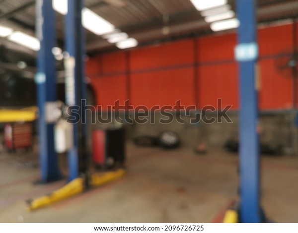 Blur focus of auto repair service station -\
electric lift for lifting cars that come to change the engine oil\
periodically in the car care\
center.