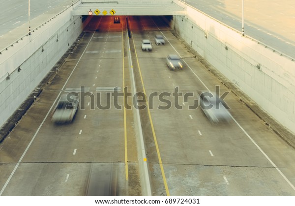 Blur focus\
of car driving in Car tunnel for\
travel