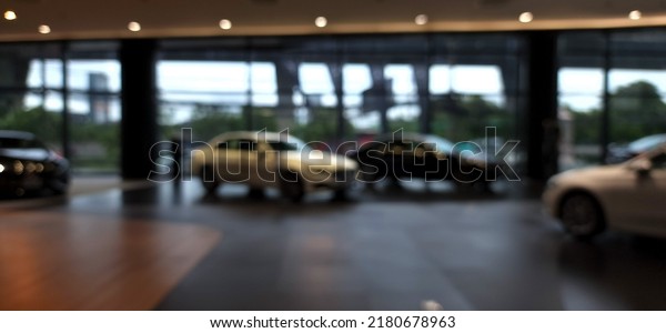 Blur focus of\
car parked in luxury showroom. Car dealership office. New car\
parked in modern showroom. Car for sale business concept.\
Automobile leasing and insurance\
concept.